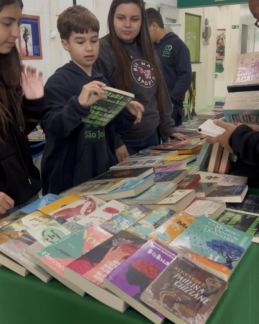 Alunos escolhendo livros na feira do livro do Colégio